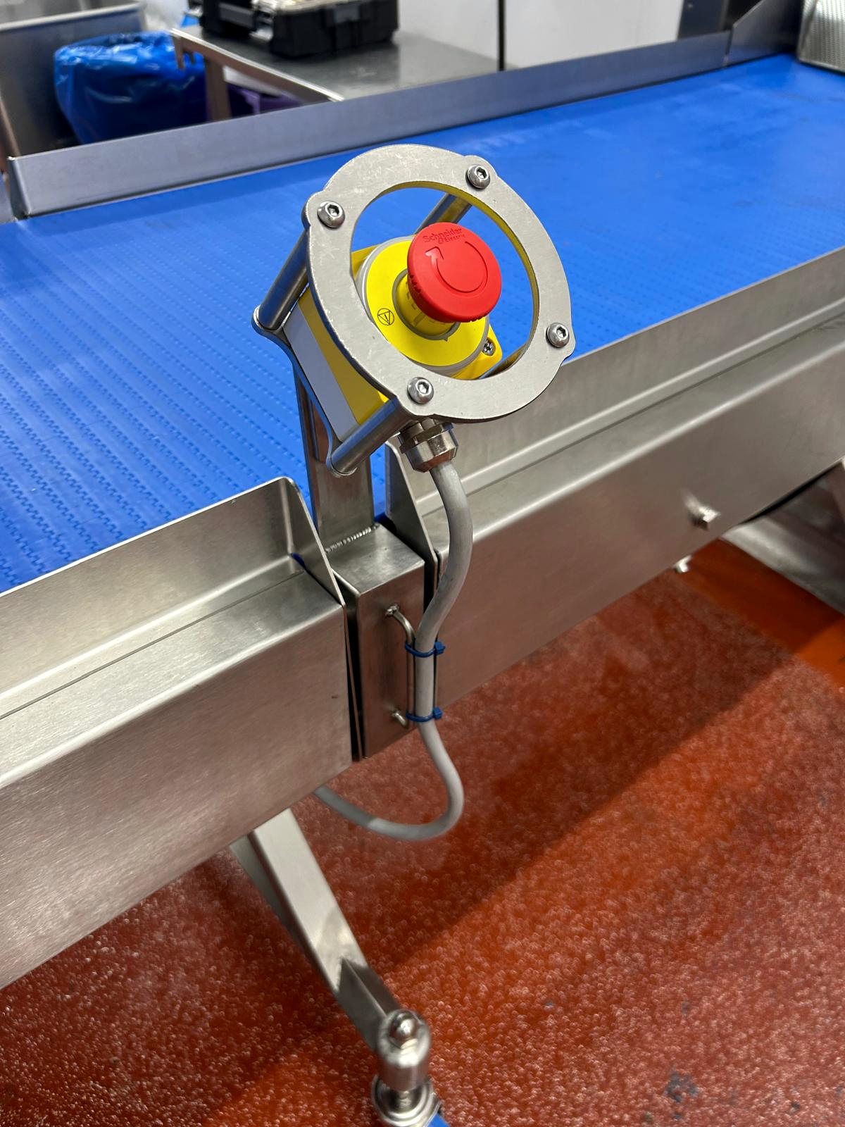 Emergency stop mounted on stainless conveyor equipment
