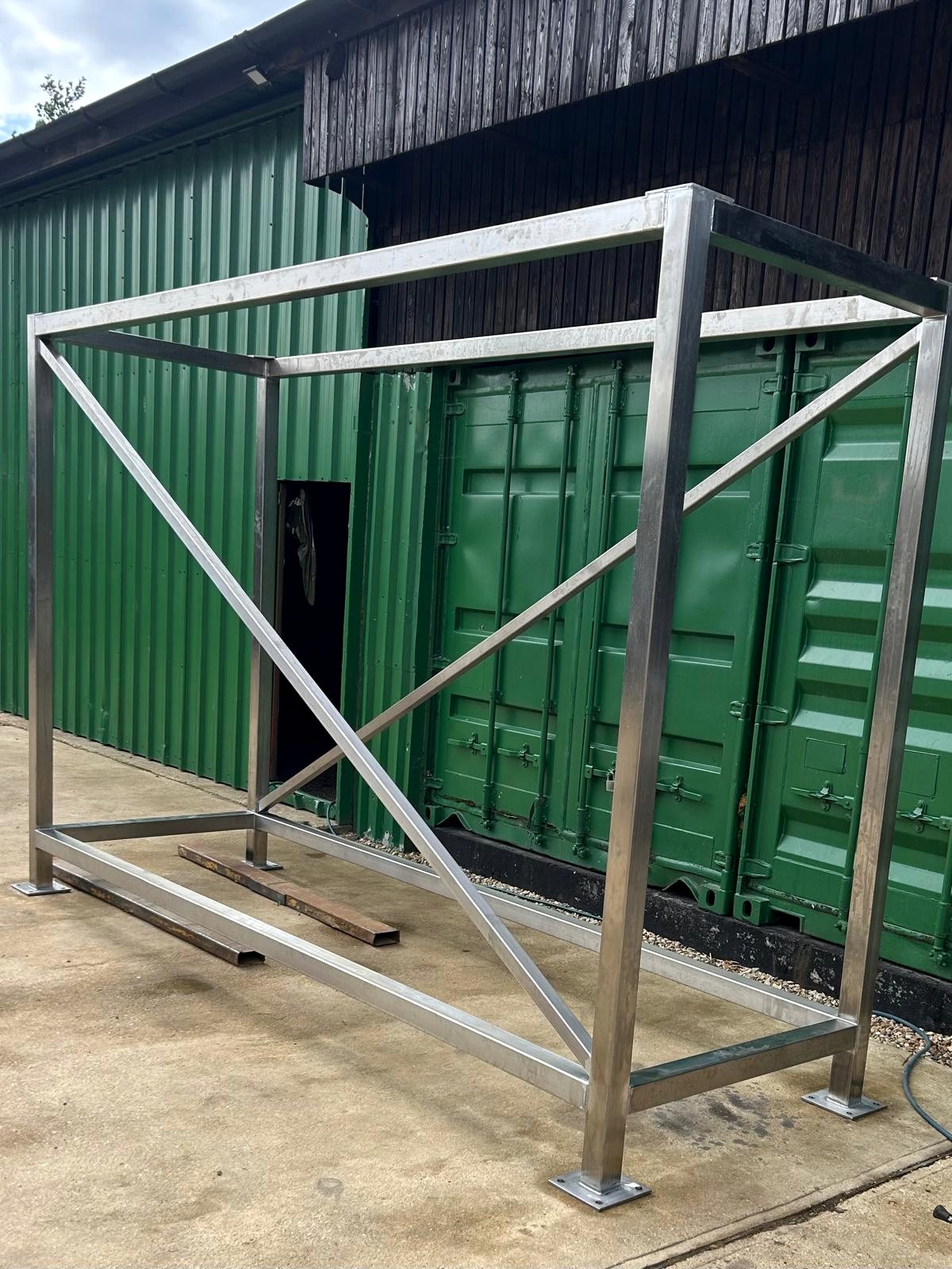 Stainless fabrication frame outside a workshop