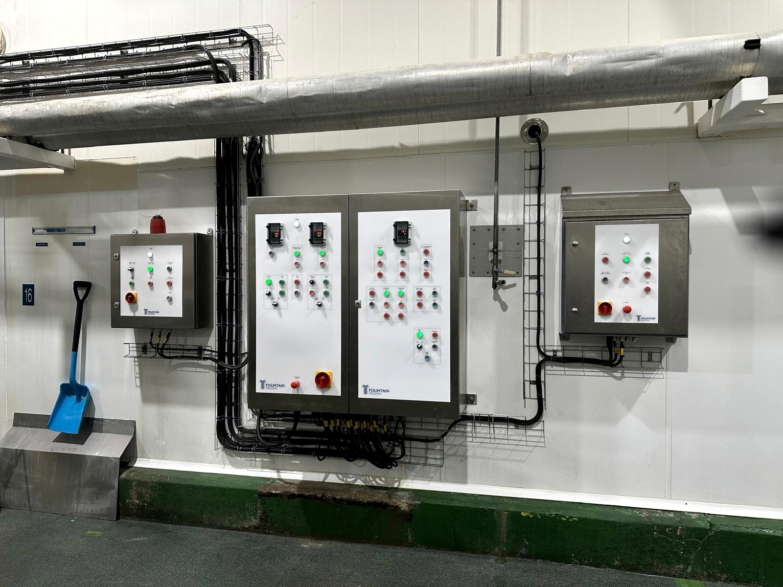 Installed stainless control panels on a production wall